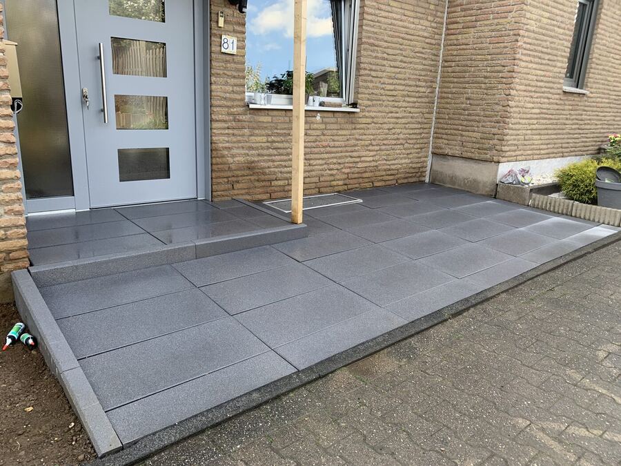 Hauseingang mit anthrazitfarbenen Betonplatten und Blockstufe, Pflasterarbeiten in Pulheim